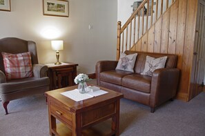 Cosy lounge with woodburning stove at Jesmond Cottage in West Burton, Wensleydale in the Yorkshire Dales