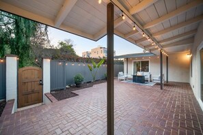 Spacious outdoor patio with gas fireplace and seating area