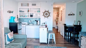 Stocked kitchen with coffee maker and coffee, toaster, pots, pans, and dishes