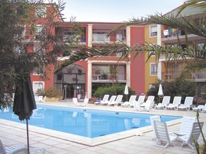 Relax under the sun around the outdoor swimming pool.