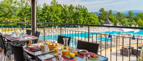 Enjoy dining outdoors on the patio overlooking the pool.