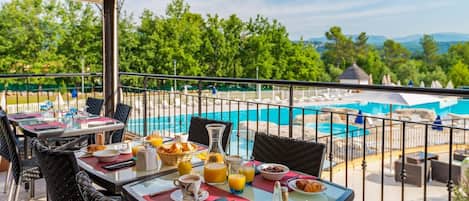 Enjoy dining outdoors on the patio overlooking the pool.