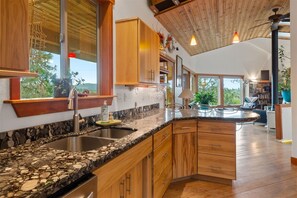 Fully equipped kitchen w granite slab counter tops