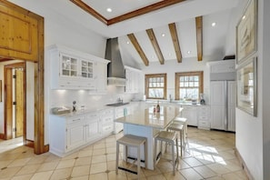 Spacious gourmet kitchen equipped with high-end appliances and plenty of counter space for culinary adventures.