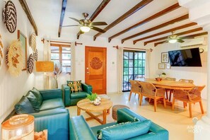 Open living space with authentic Mexican art & decor & wood-beamed ceilings