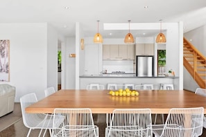 Whether you’re enjoying a casual breakfast at the island bench or family meals at the large dining table, this space is designed to bring people together