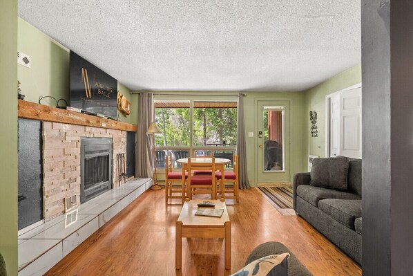 Living room with a smart TV with cable, cozy seating, pull-out sofa bed & a decorative fireplace (glow logs only!)