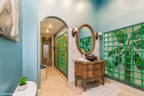 2/2 Master bathroom with toilet, sink, bench and full shower. 