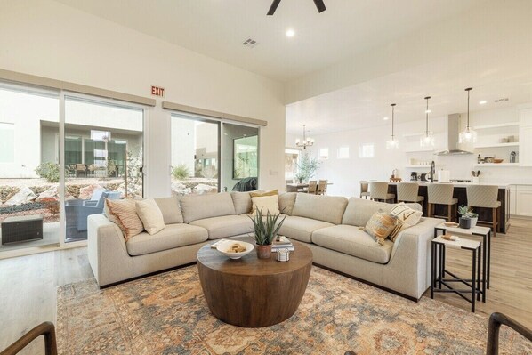 A large sectional couch and the open floor plan provide comfort and convenience for all guests to gather.