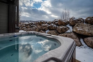 Enjoy the private hot tub, tucked in on the lower level patio.