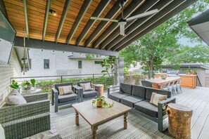 Covered deck with plenty of comfy seating and a ceiling fan to keep things cool.