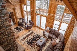 Large Family Room with view to back porch/pool and floor to ceiling fireplace. 