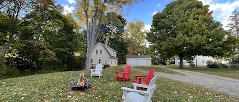 Front yard with plenty of parking, fire pit, and chairs