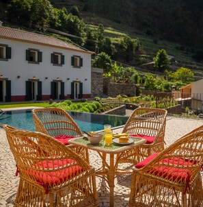 Pool area with chairs and a small table 