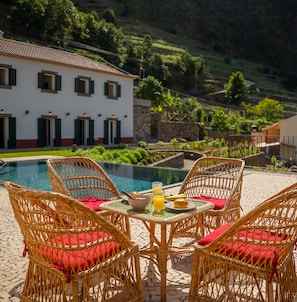 Pool area with chairs and a small table
