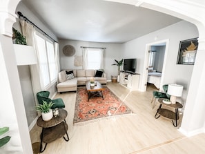 View of living room with downstairs bedroom and attached half-bath!