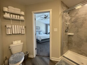 Attached bathroom with walk-in shower and dual vanity sink