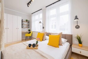 A bright living room with yellow accents, white walls, and minimalist furniture, creating a playful and elegant ambiance.
