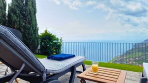 Unwind on a sunbed with a breathtaking ocean view at Villa Antonina in Arco da Calheta. #holidays #calheta #villa