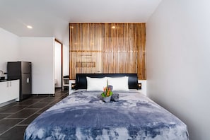 king sized bed with hypoallergenic sheets and backdrop