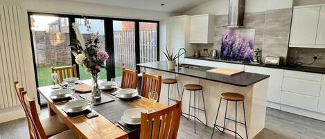 Light and airy, island kitchen and dining space with double bifolds