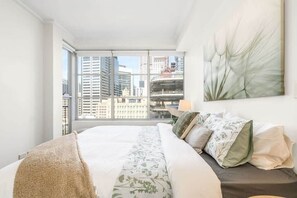 A bedroom with a king sized bed & plush pillows.
