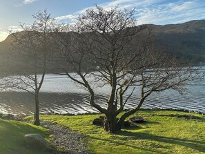 With its own landscaped shore, sea wall and firepit next to the beach | Tigh-na-Creige, Colintraive