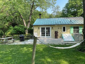 Hammock, grill & large picnic table in the backyard.