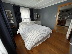 Queen bed with cozy down comforter, extra pillows, and blackout curtains.