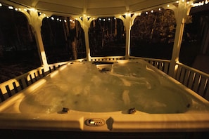 Romantic hot tub in the gazebo with fairy lights.