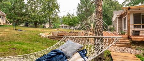 Relax in the peaceful hammock next to the flowing stream