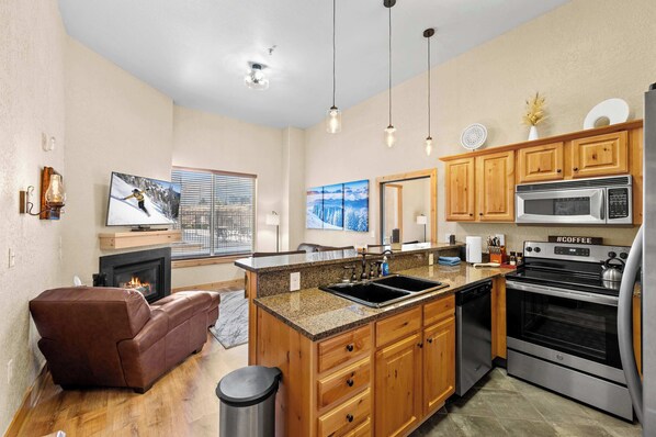 Main living space: Open layout, well equipped kitchen, living room, couch w/ full Queen super sleeper flip-out bed, 48” Smart TV, electric fireplace
