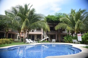 The community pool has plenty of space, lounge chairs and a covered ranch area...all in a beautiful tropical setting.