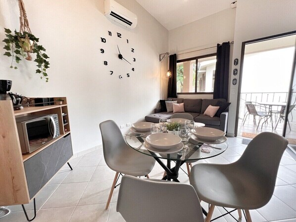 Open living, dining and kitchen.  This space has high, vaulted ceilings and access to the covered terrace.