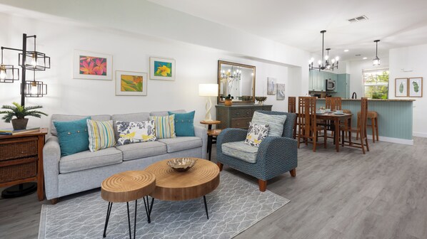 Living room with bright and modern furniture including a queen size sleeper sofa