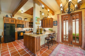 Fully Equipped Kitchen / Service for 12 downstairs / Bar stools.