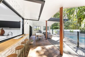 Kitchen Bar and servery window on gas struts bring the outside inside