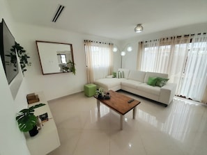 Our living area has airconditioning, sliding door to a small cozy garden!