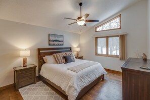 Upper level master bedroom with a king sized bed and large dresser