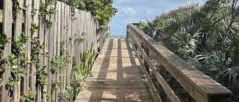 Walkway to private beach access with showers for rinsing & golf cart parking!