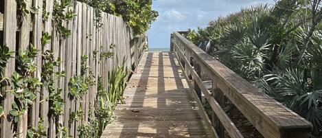 Walkway to private beach access with showers for rinsing & golf cart parking!