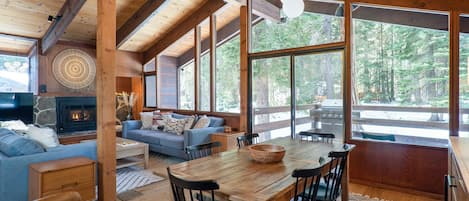 Open concept with wall of Windows looking to the private, forested backyard