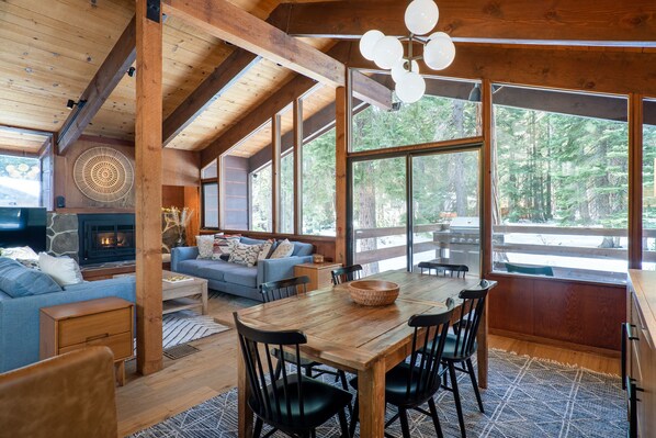 Open concept with wall of Windows looking to the private, forested backyard