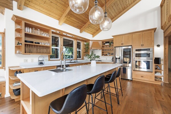 Huge island and beautiful open shelves stocked with everything you need for 12
