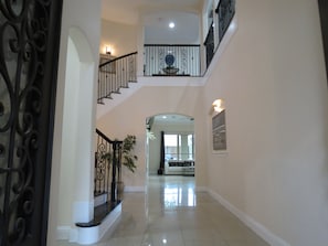 Imagine walking through the French iron doors into this Cinderella staircase.