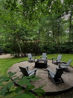 Spacious firepit with seating for 6, bistro lights, and firewood provided 