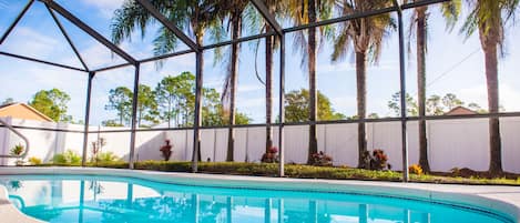 Heated Pool in Screened-In Lanai, Palm trees in backyard