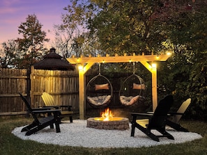 Custom fire pit with hanging chairs and new Adirondack chairs