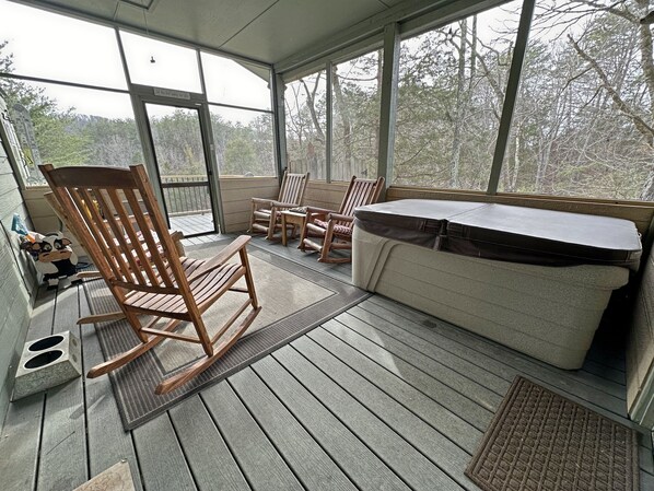 Newly redone! What a wonderful screened in porch. Rocking chairs and a hot tub. 