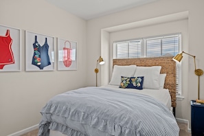 Queen size bed and vintage swimsuits decorate the walls throughout the home 